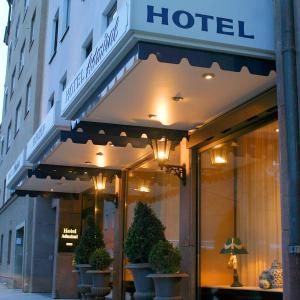 a hotel building with potted plants in front of it at Hotel Admiral in Munich