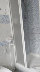 a shower with a glass door in a bathroom at Country House La Scortica in Beverino
