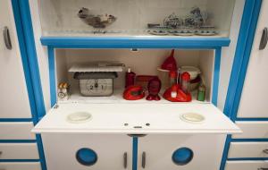 a toy kitchen with a blue and white cabinet at Domus Liberta - Boutique Rooms in Trieste