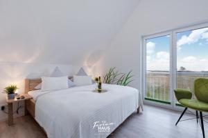 a bedroom with a bed and a large window at Inselperle in Olpenitz