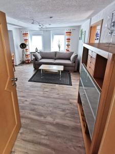 a living room with a couch and a coffee table at Ferienwohnung Am Salzbach in Lemberg