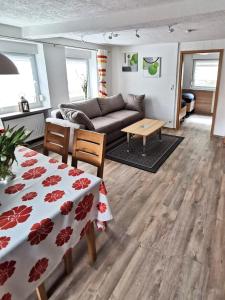 a living room with a couch and a table at Ferienwohnung Am Salzbach in Lemberg