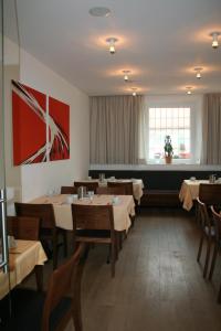 a restaurant with tables and chairs in a room at Landhotel Sickinger Hof in Walldorf