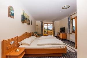 Postel nebo postele na pokoji v ubytování Hotel Fasching