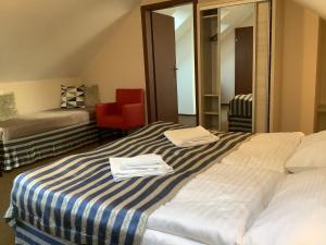 a hotel room with a bed with towels on it at Amberia Mikołajki in Mikołajki