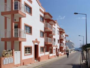
a street scene with buildings and cars at Apartamentos Monte da Vinha I in Albufeira
