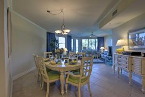 a kitchen and dining room with a table and chairs at Oceanfront Retreat Modern Living on Miramar Beach in Destin