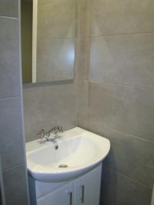a bathroom with a white sink and a mirror at Квартира студия в центре Чернигова wi-fi in Chernihiv