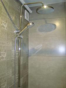 a shower with a glass door in a bathroom at Квартира студия в центре Чернигова wi-fi in Chernihiv