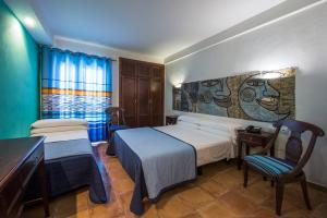 Postel nebo postele na pokoji v ubytování Hotel de Naturaleza Rodalquilar & Spa Cabo de Gata