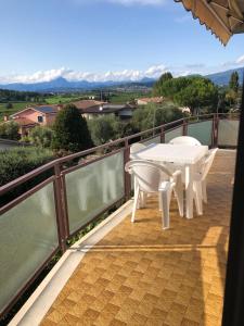a balcony with a table and chairs on it at Casa Magnolia in Pastrengo