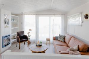 a living room with a couch and a table at Noordkop vakanties in Westerland