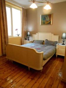 a bedroom with a large bed and two windows at Orient Express Guest House in Sofia