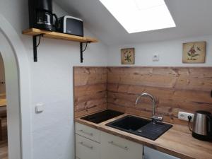 a kitchen with a sink and a counter top at Riverside Apartment in Garmisch-Partenkirchen