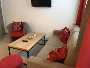 a living room with a couch and a table at Pension Lagler in Heiligenblut