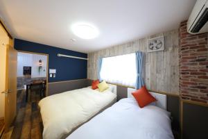a bedroom with two beds and a window at Prosper 6th Building 2F / Vacation STAY 7562 in Nagoya