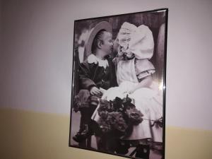 a framed picture of a child kissing a woman at Hotel Pigalle in Rimini