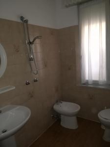 a bathroom with a sink and a toilet and a shower at Hotel Pigalle in Rimini