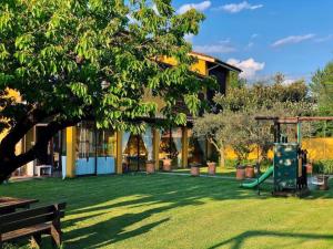 a house with a playground in the yard at Agriturismo La Conte in Lucca