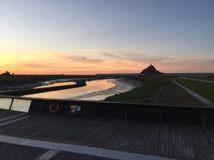 a view of a river at sunset from a bridge at Au Bon Accueil in Saint-Marcan