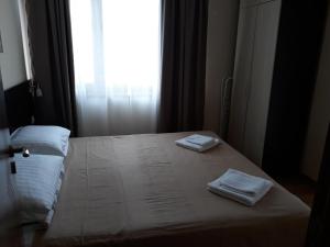 a bedroom with a bed with two towels on it at Villa Maria in Tsarevo