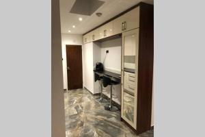 a home office with a desk and a counter at Bright, stylish Studio flat with Sky Sports in Earley +6 photos