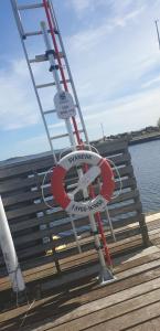 a ladder and a sign on a boardwalk at Sailboat Chanel in Karlshamn