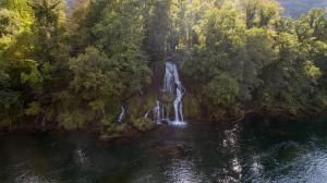 an aerial view of a waterfall in a forest at Garni Hotel Vila Drina in Perućac