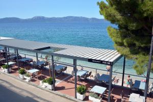 a view of a beach with chairs and the water at Guesthouse Kod Irene in Gradac