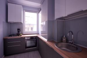 a kitchen with a large sink and a window at Atlantis Apartment in Mamaia Sat/Năvodari