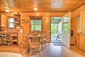 a kitchen and dining room with a table and chairs at Rustic Davis Cabin Less Than half Mile to Turner Falls! in Davis