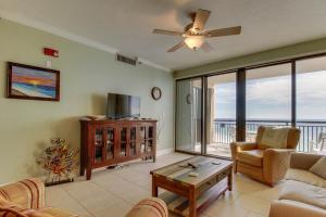 a living room with a couch and a ceiling fan at Navarre Towers Condos in Navarre