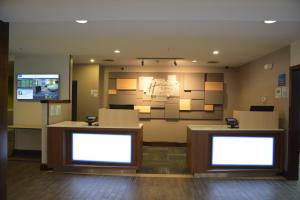 a waiting room with two desks and a tv at Holiday Inn Express & Suites Caryville by IHG in Caryville +26 photos