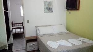 Cama ou camas em um quarto em Hotel Paulista