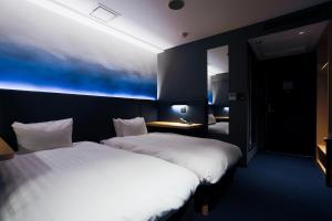 Postel nebo postele na pokoji v ubytování Hotel New Shohei