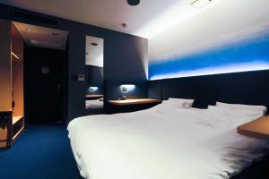 Postel nebo postele na pokoji v ubytování Hotel New Shohei