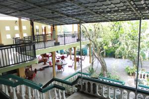 a building with a balcony with tables and chairs at Wijaya Tourist INN in Warakapola
