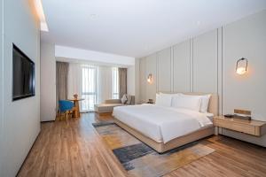 Voodi või voodid majutusasutuse Nanan Ao Sheng Yi Hao Hotel toas