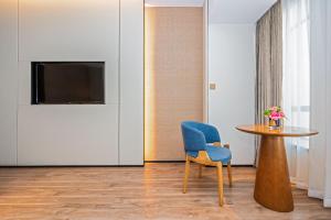 Televiisor ja/või meelelahutuskeskus majutusasutuses Nanan Ao Sheng Yi Hao Hotel