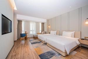 Voodi või voodid majutusasutuse Nanan Ao Sheng Yi Hao Hotel toas