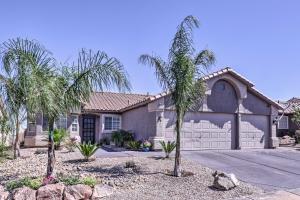 a house with palm trees in front of a driveway at Pool Home with Spectacular Strip and Mountain Views! in Las Vegas