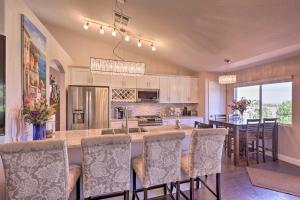a kitchen with a large island with bar chairs at Pool Home with Spectacular Strip and Mountain Views! in Las Vegas