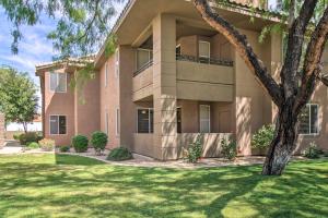 a large building with a green lawn in front of it at Scottsdale Condo with Pool Walk to Kierland Resort in Scottsdale
