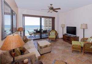 a living room with a couch and a flat screen tv at 3 Br CONDO AVAILABLE IN LAS PALOMAS SANDY BEACH in Puerto Peñasco
