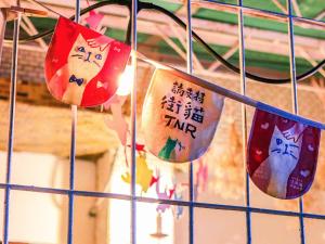 a group of flags hanging from a fence at Red Letter Day in Tainan