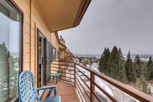 a balcony with two chairs and a view of the snow at Buffalo Ridge Condos in Silverthorne