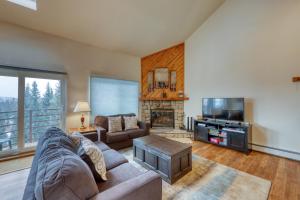 a living room with a couch and a tv at Buffalo Ridge Condos in Silverthorne