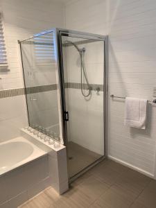 a bathroom with a shower and a sink at Short Stays Gippsland (Newborough) in Moe