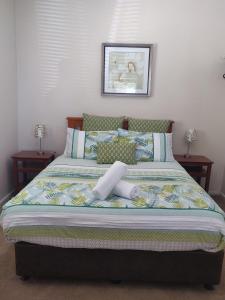 a bed in a bedroom with two night stands at Lilacs Waterfront Villas & Cottages in Albany