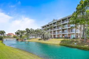 an apartment building with a river in front of it at Gulf Place Caribbean in Santa Rosa Beach